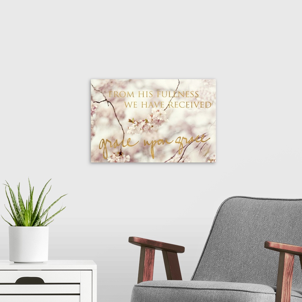 A modern room featuring Shallow depth of field photograph of cherry blossom branches and the phrase "From His fullness we...