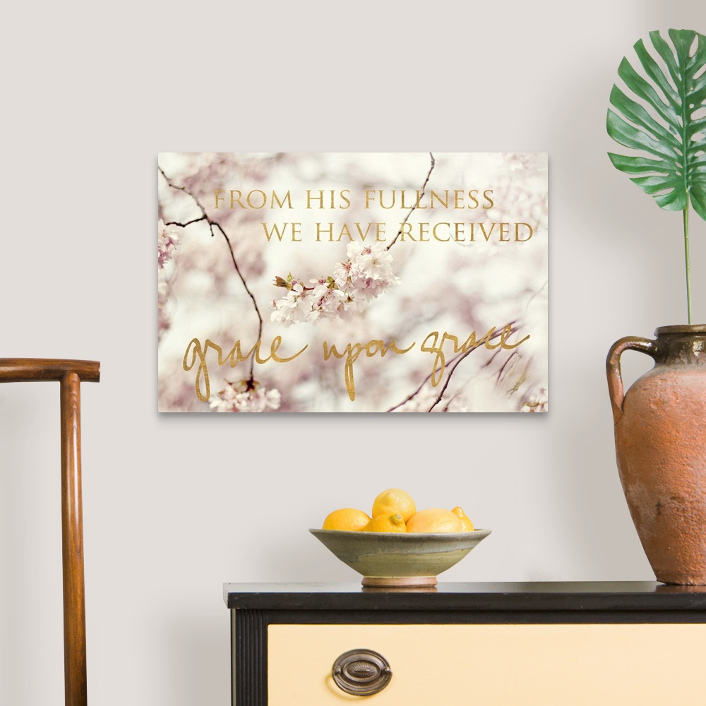 A traditional room featuring Shallow depth of field photograph of cherry blossom branches and the phrase "From His fullness we...