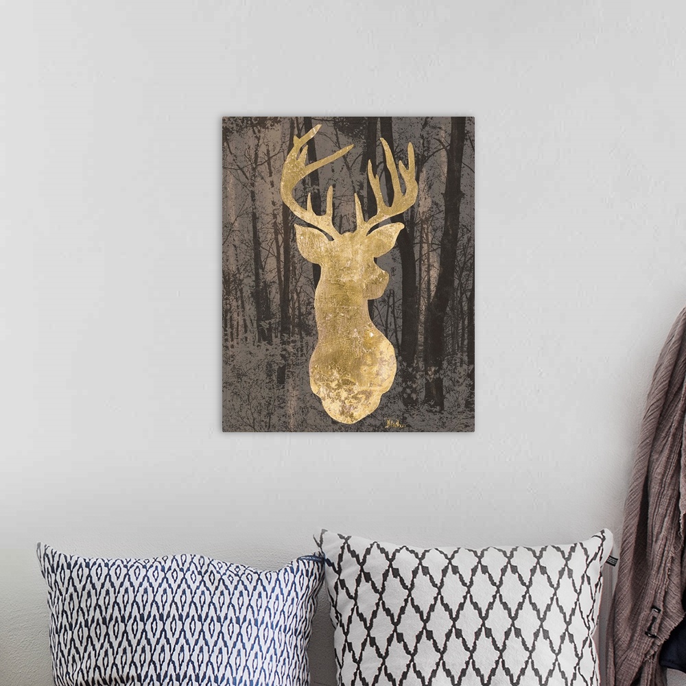 A bohemian room featuring Metallic gold silhouette of a deer on a dark background filled with trees.