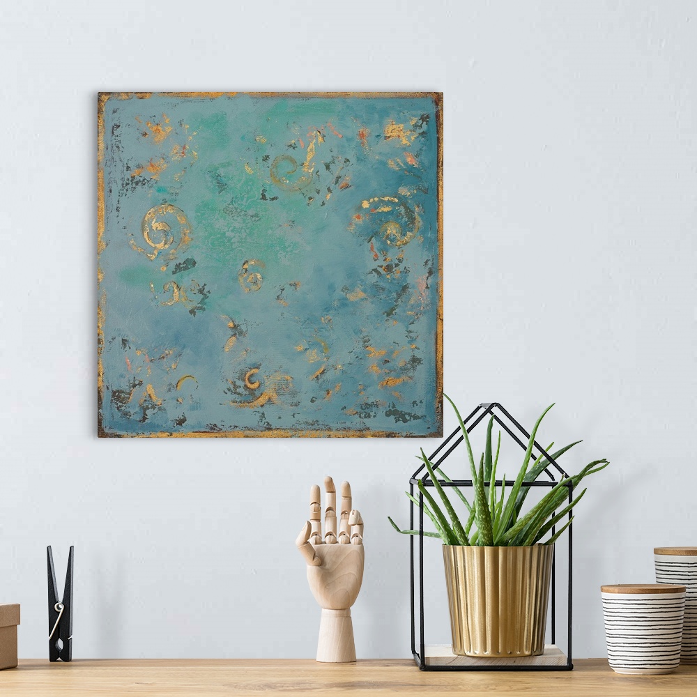 A bohemian room featuring A contemporary abstract painting of gold swirls on a blue background with hints of green.