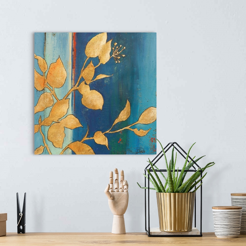 A bohemian room featuring Contemporary painting with an abstract blue background with gold silhouetted leaves in the foregr...