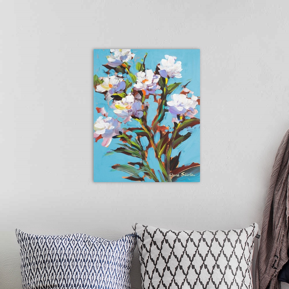 A bohemian room featuring Contemporary painting of several white flowers in bloom.