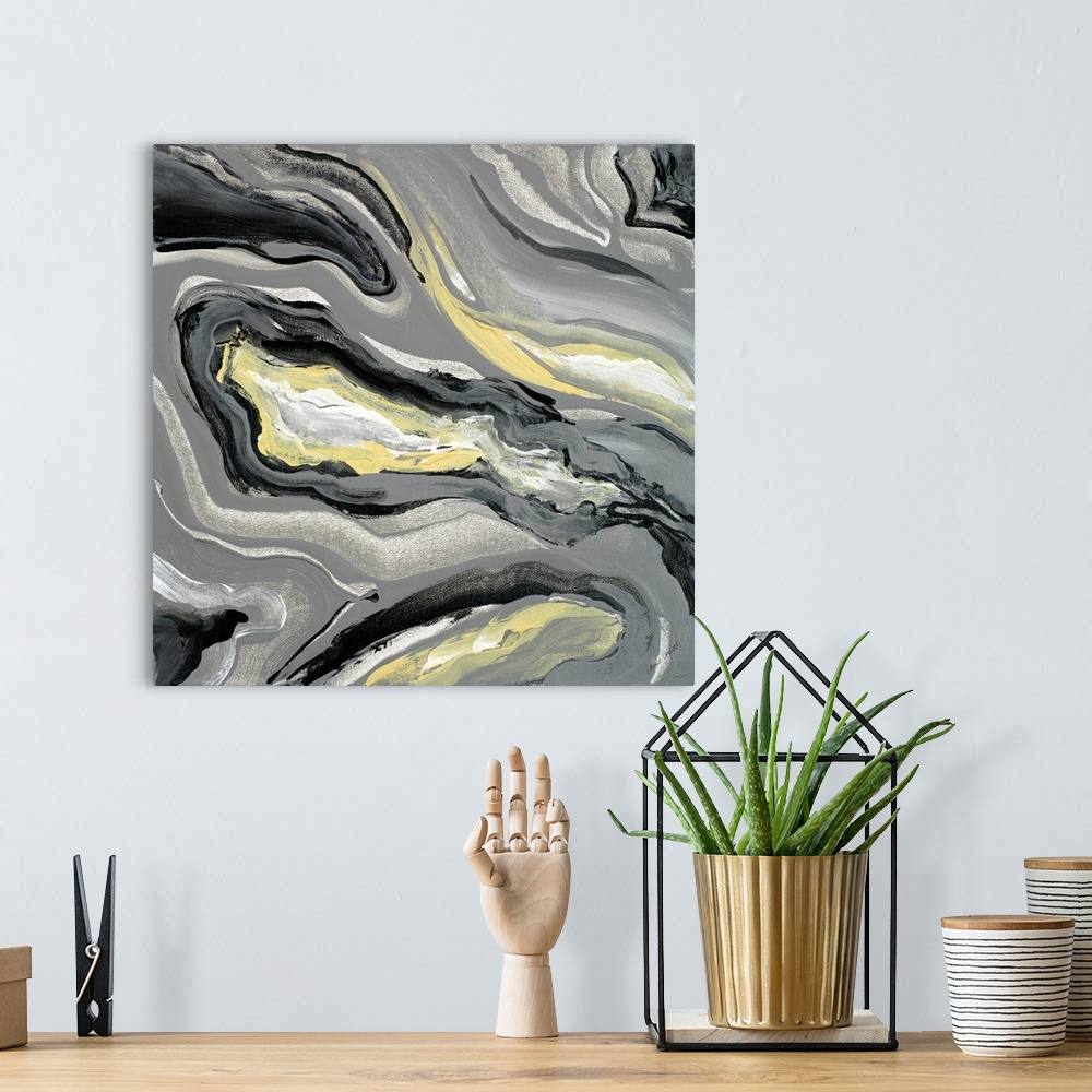 A bohemian room featuring Square abstract painting of a gray, yellow, and white geode.
