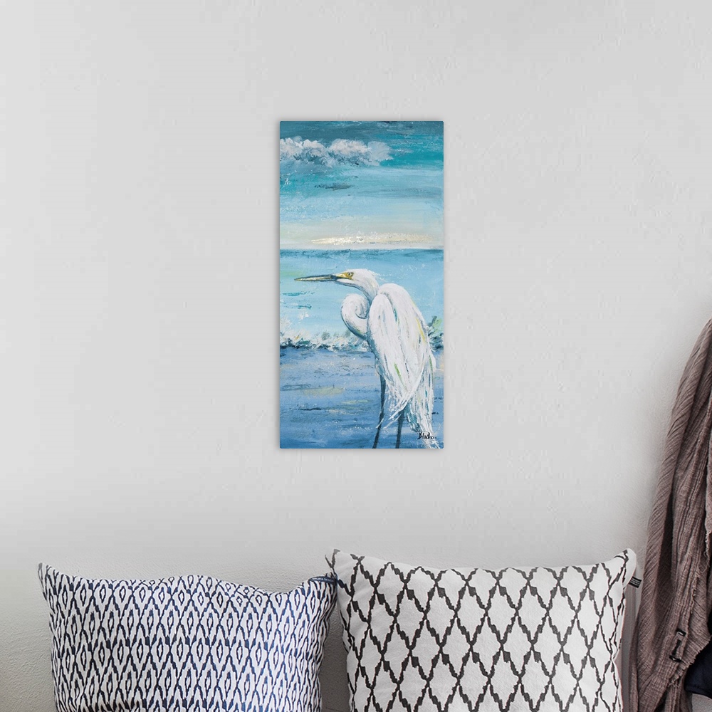A bohemian room featuring Contemporary painting of a white egret overlooking the blue water.