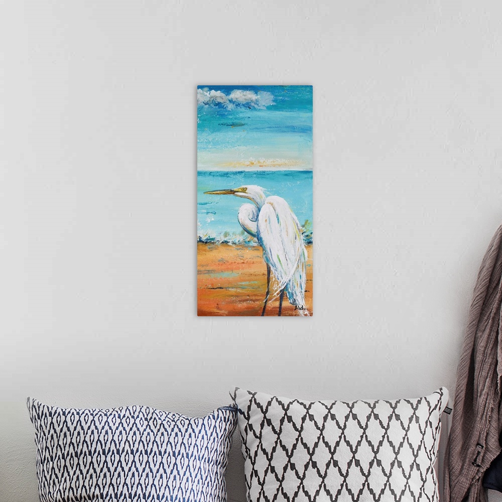 A bohemian room featuring Contemporary painting of a white egret standing on a sand beach with the ocean in the background.