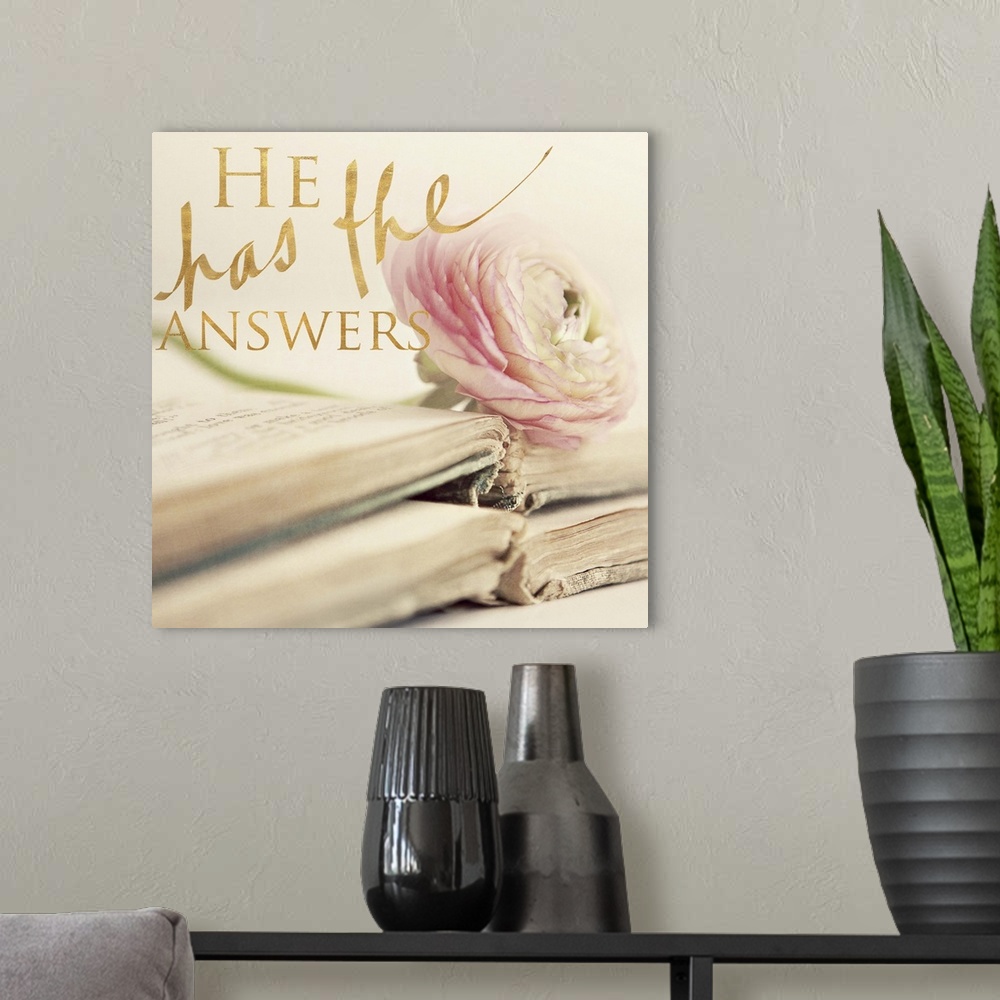 A modern room featuring A photograph of two antique books stacked on top of each other with one pink/white rose on top wi...