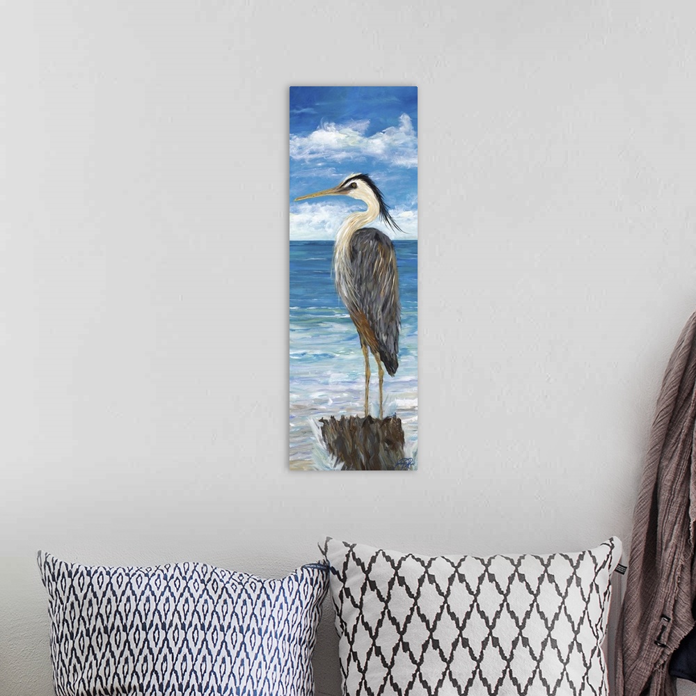A bohemian room featuring A Great Blue Heron standing on a post, overlooking the water.