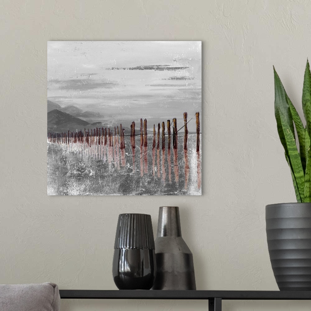 A modern room featuring Square abstract painting of brown pier remains  in gray and white textured water with mountains i...
