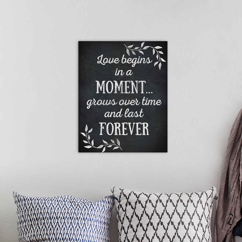 A bohemian room featuring Chalkboard sign that reads "Love begins in a Moment... grows over time and lasts Forever"