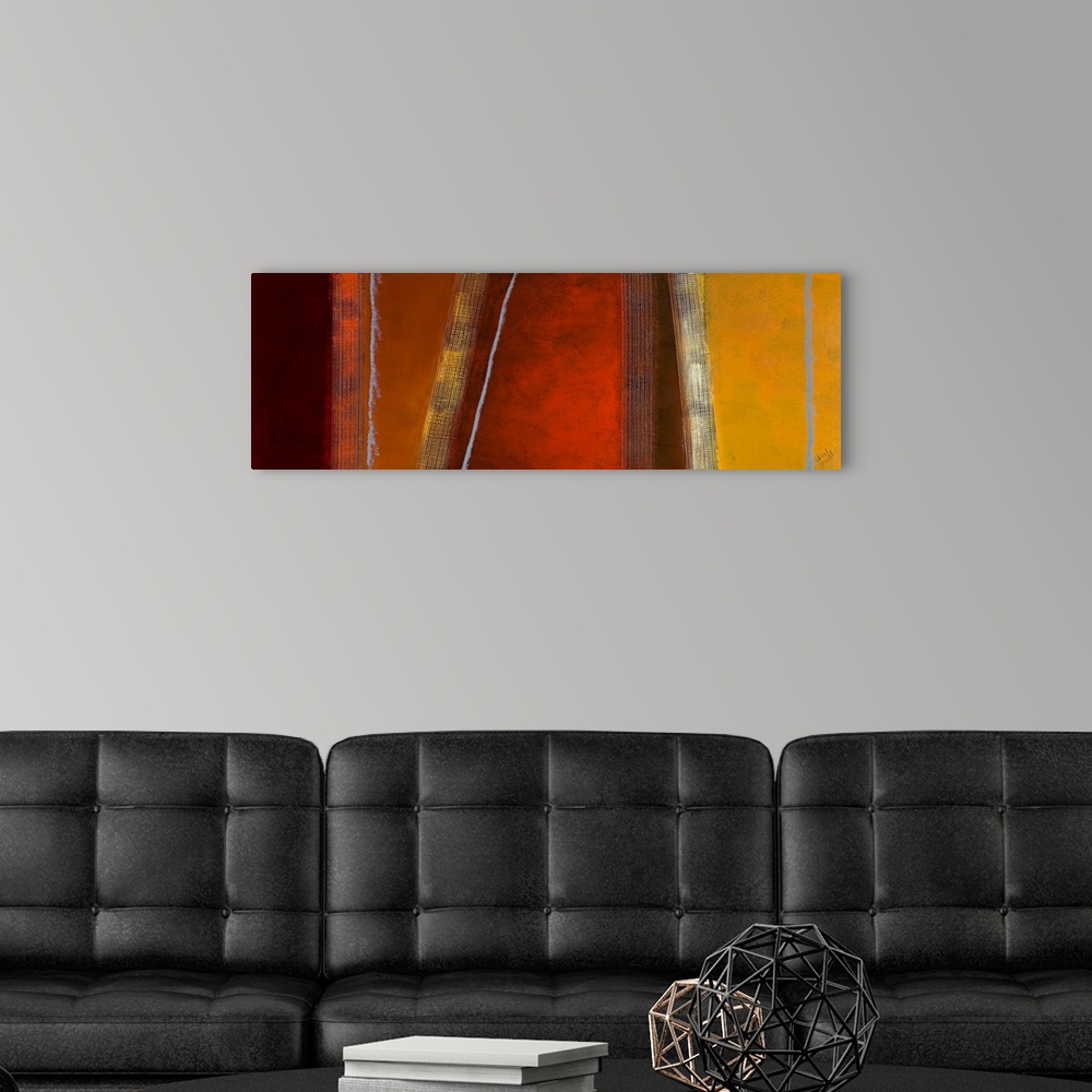 A modern room featuring Panoramic abstract art composed of different earth toned sections separated by vertical and diago...