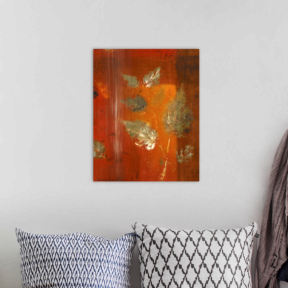 A bohemian room featuring Contemporary artwork in oranges and reds with leaf imprints.
