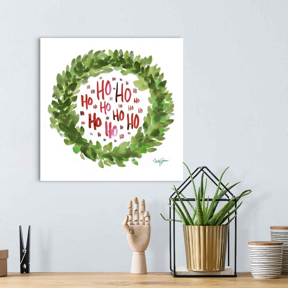 A bohemian room featuring Square watercolor painting of a green Christmas wreath with "Ho" written inside in red several ti...