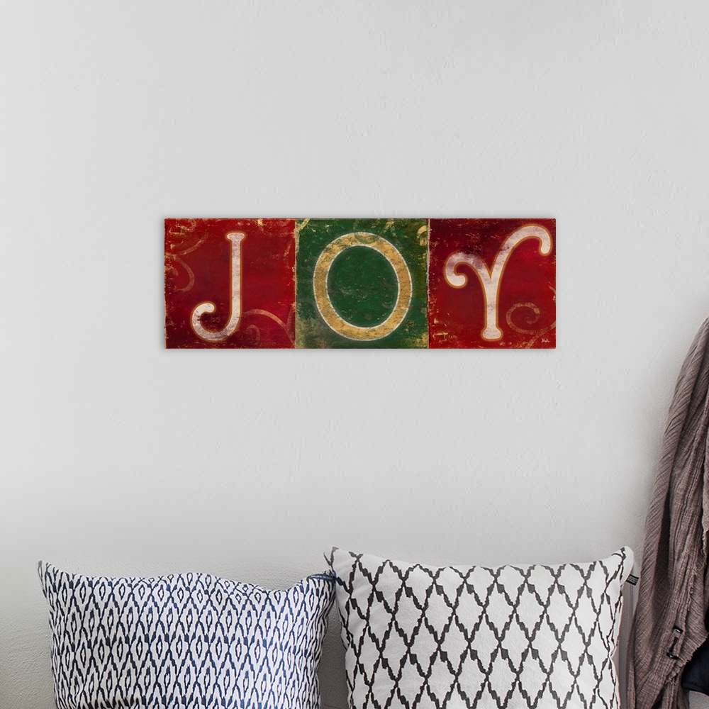 A bohemian room featuring Seasonal artwork of the word "Joy" in green and red squares.