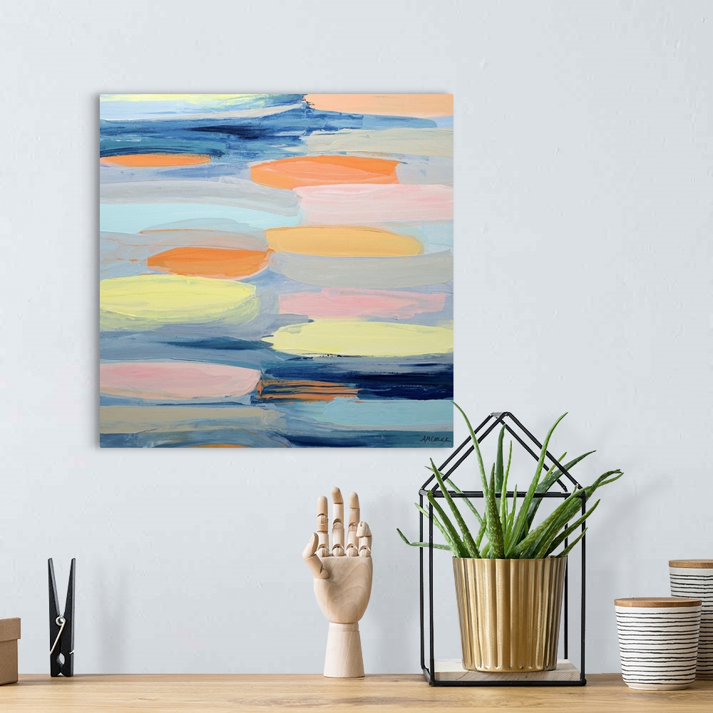 A bohemian room featuring Blue, yellow, and orange abstract artwork.