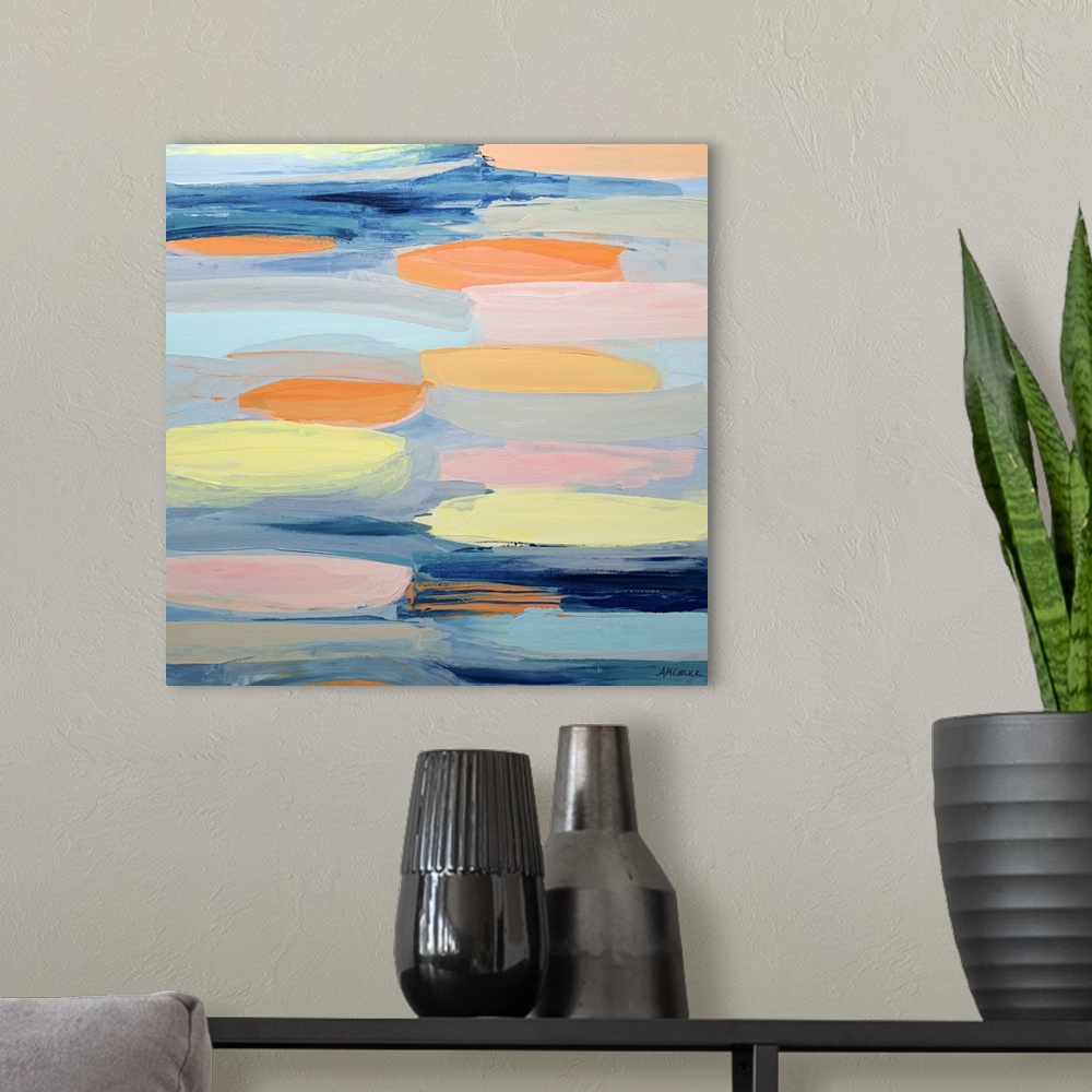 A modern room featuring Blue, yellow, and orange abstract artwork.