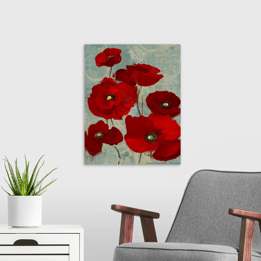 A modern room featuring Mixed Media artwork of a bunch of poppy blooms with brilliant red petals on thin stems on a light...