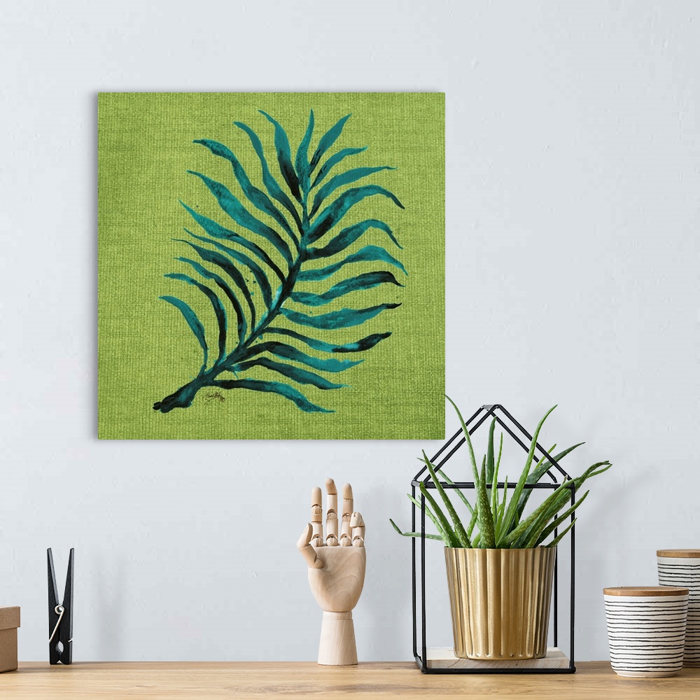 A bohemian room featuring Square watercolor painting of a blue-green palm leaf on a green burlap background.