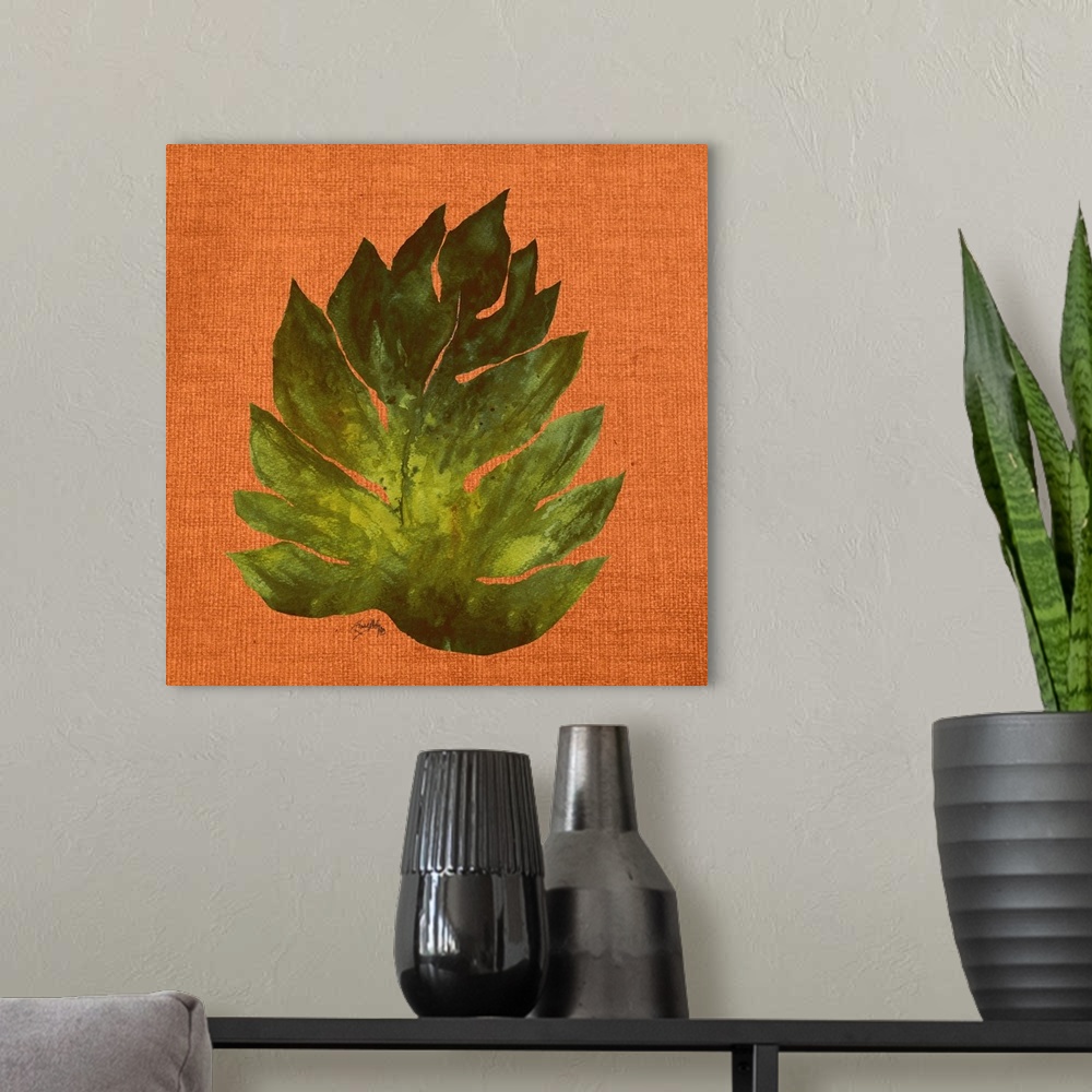 A modern room featuring Square painting of a big green leaf on an orange burlap background.