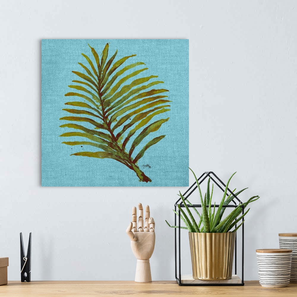 A bohemian room featuring Square watercolor painting of a green palm leaf on a light blue burlap background.
