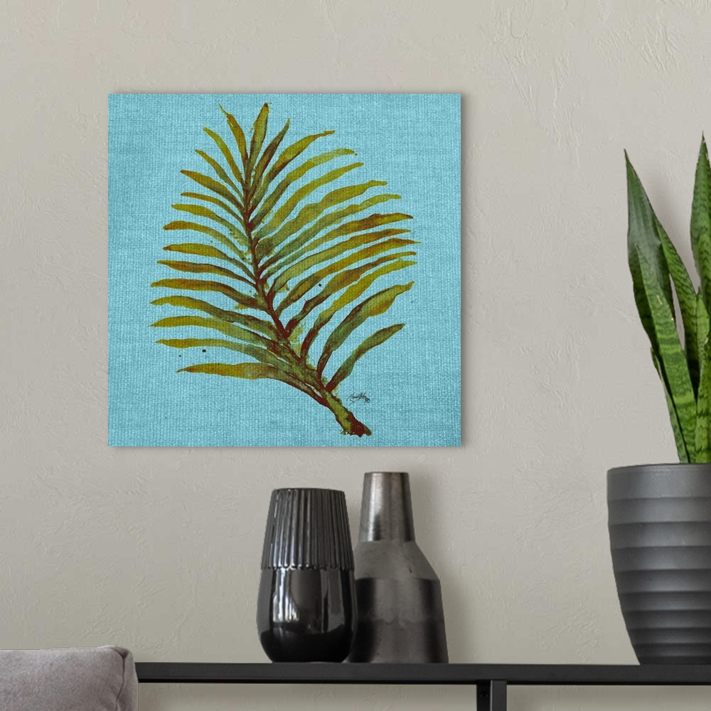 A modern room featuring Square watercolor painting of a green palm leaf on a light blue burlap background.