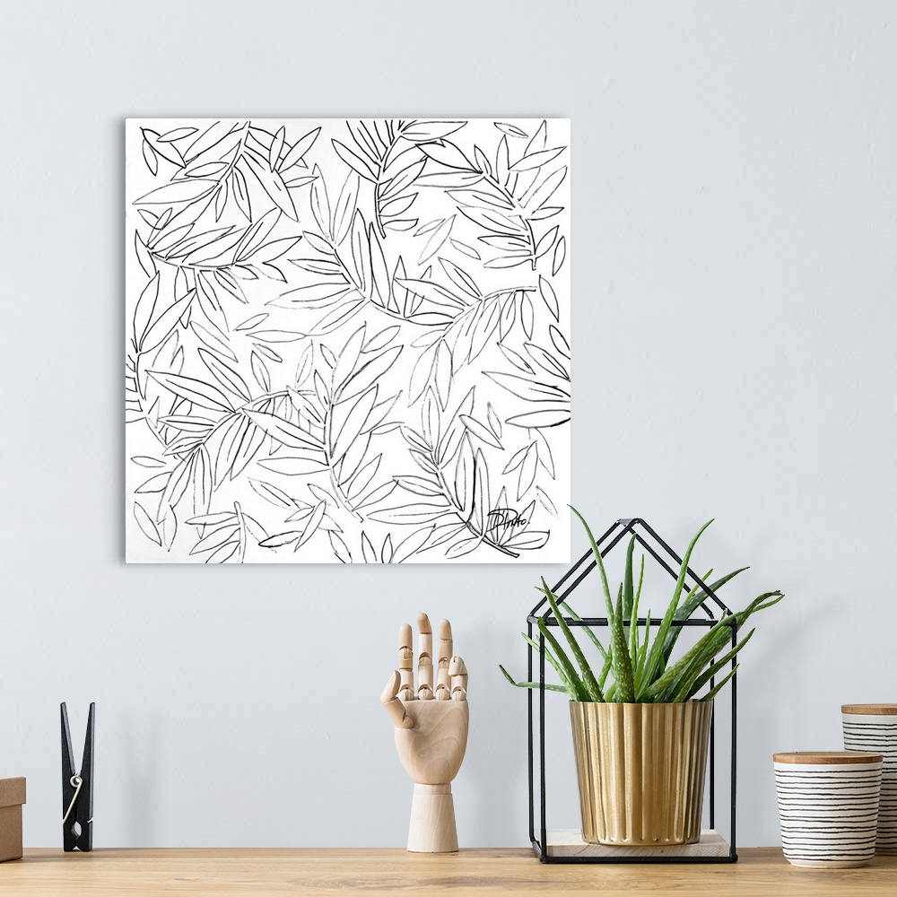 A bohemian room featuring A black and white sketch of leaves and branches.