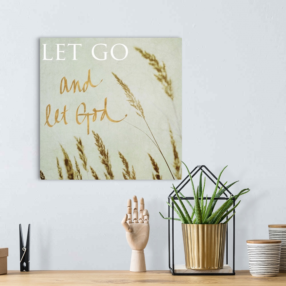 A bohemian room featuring Square photograph of the tips of beach grass swaying in the wind with the quote "Let Go and Let G...
