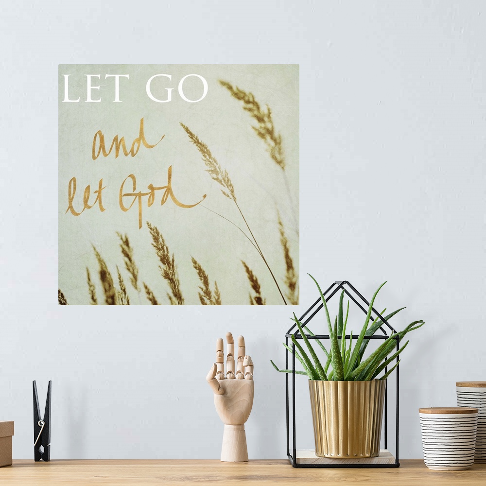 A bohemian room featuring Square photograph of the tips of beach grass swaying in the wind with the quote "Let Go and Let G...