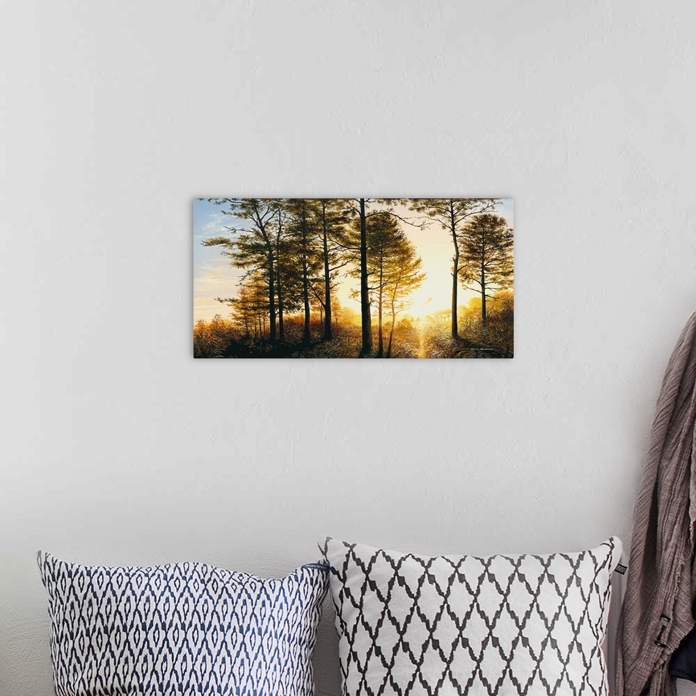 A bohemian room featuring A painting of the woods with a bright yellow sunrise.