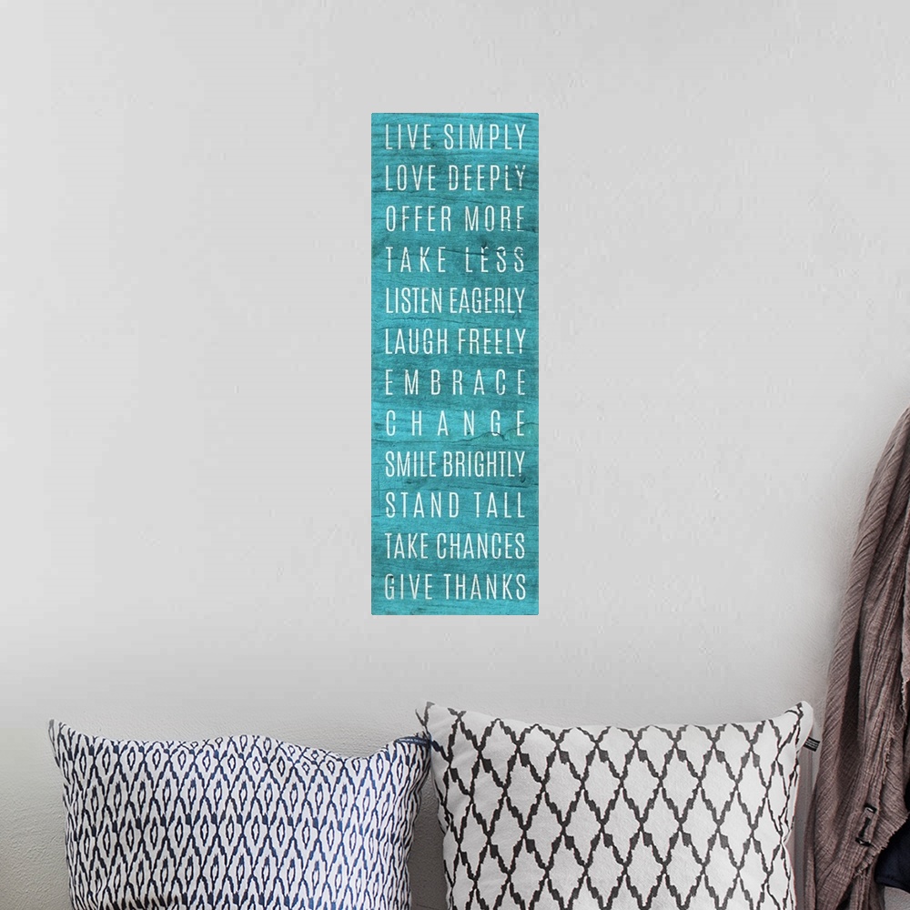 A bohemian room featuring A list of "rules" for living well in white lettering on teal blue.