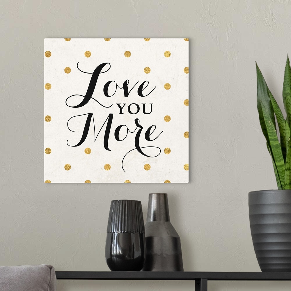 A modern room featuring The words "Love You More" in black script on a cream background with gold dots.
