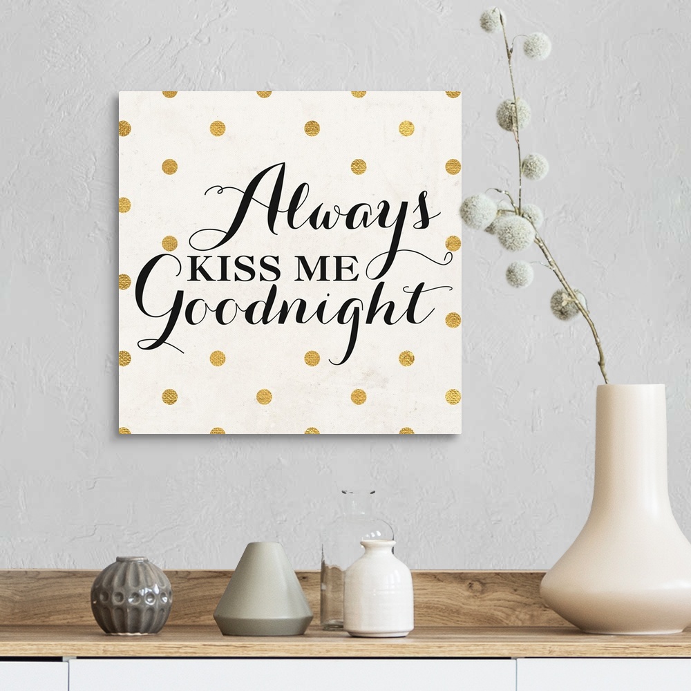 A farmhouse room featuring The words "Always Kiss Me Goodnight" in black script on a cream background with gold dots.