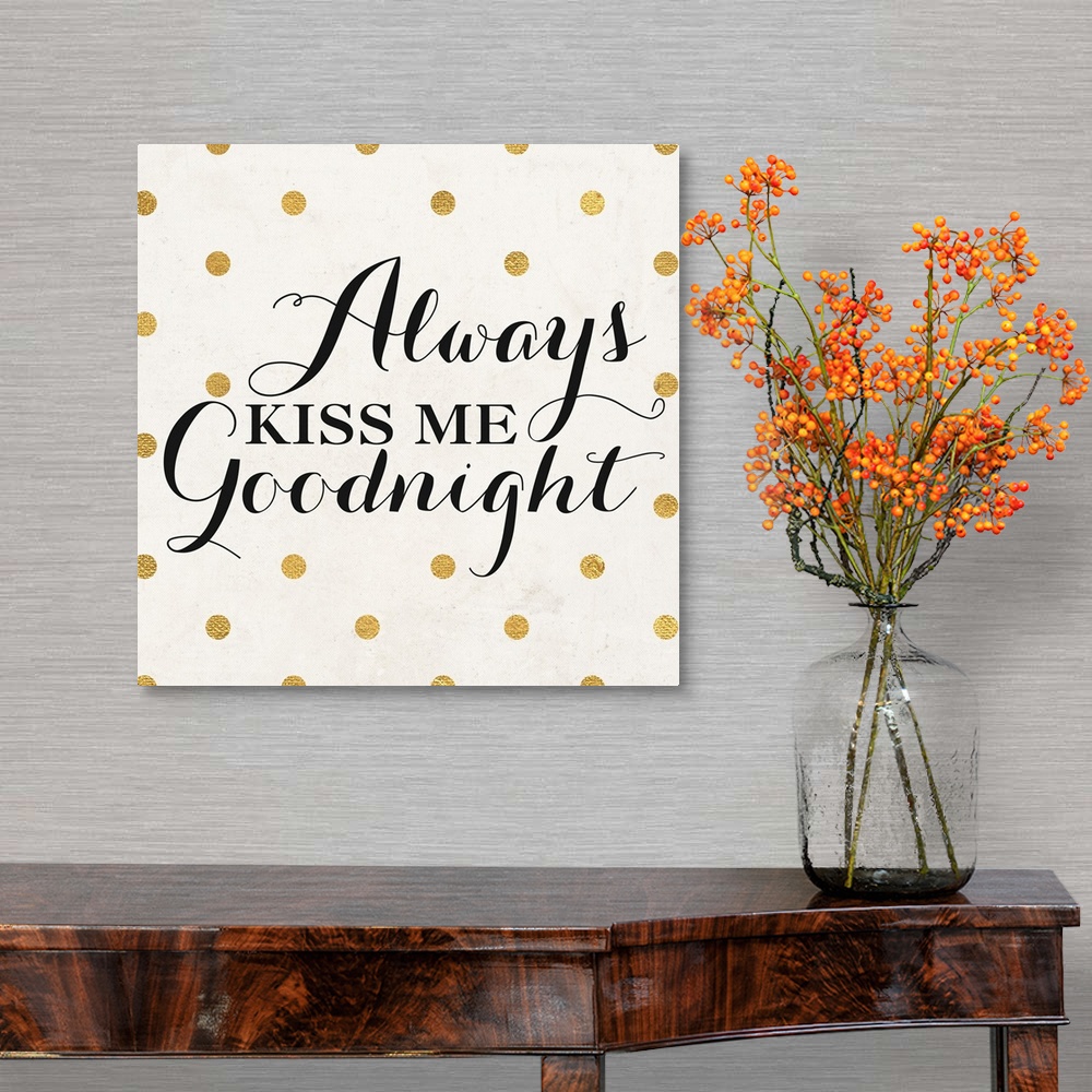 A traditional room featuring The words "Always Kiss Me Goodnight" in black script on a cream background with gold dots.