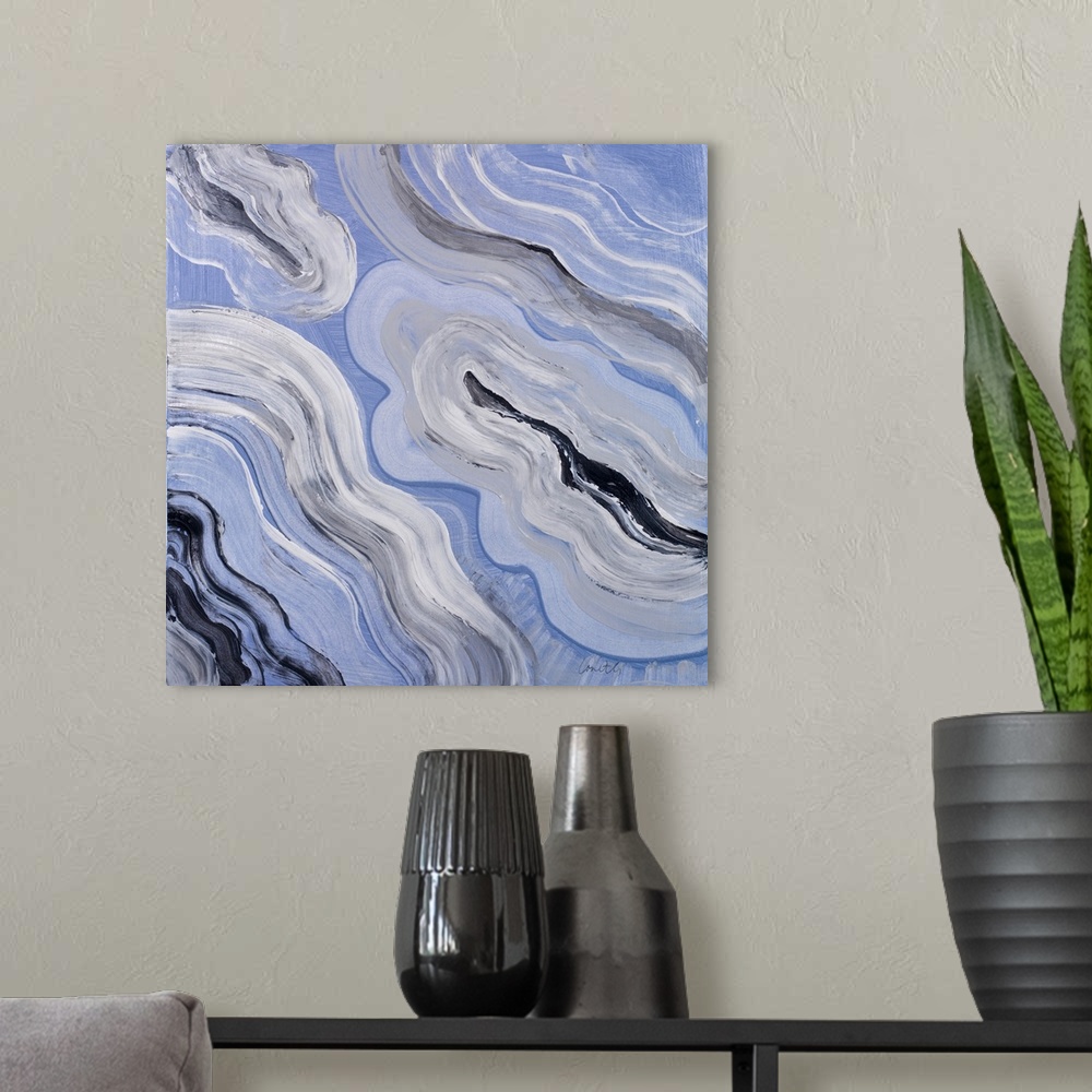 A modern room featuring Square abstract painting of agate in shades of blue with gray, black, and white.