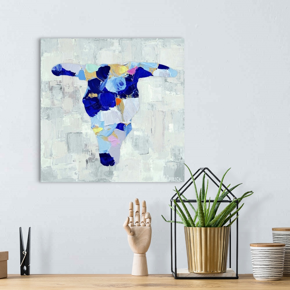 A bohemian room featuring Semi-abstract painting of a cattle skull in vibrant blue shades.