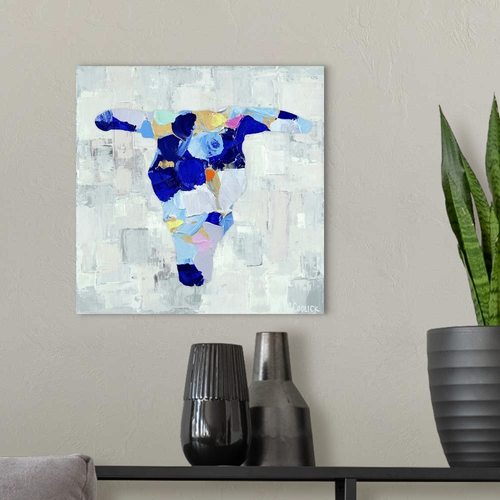 A modern room featuring Semi-abstract painting of a cattle skull in vibrant blue shades.