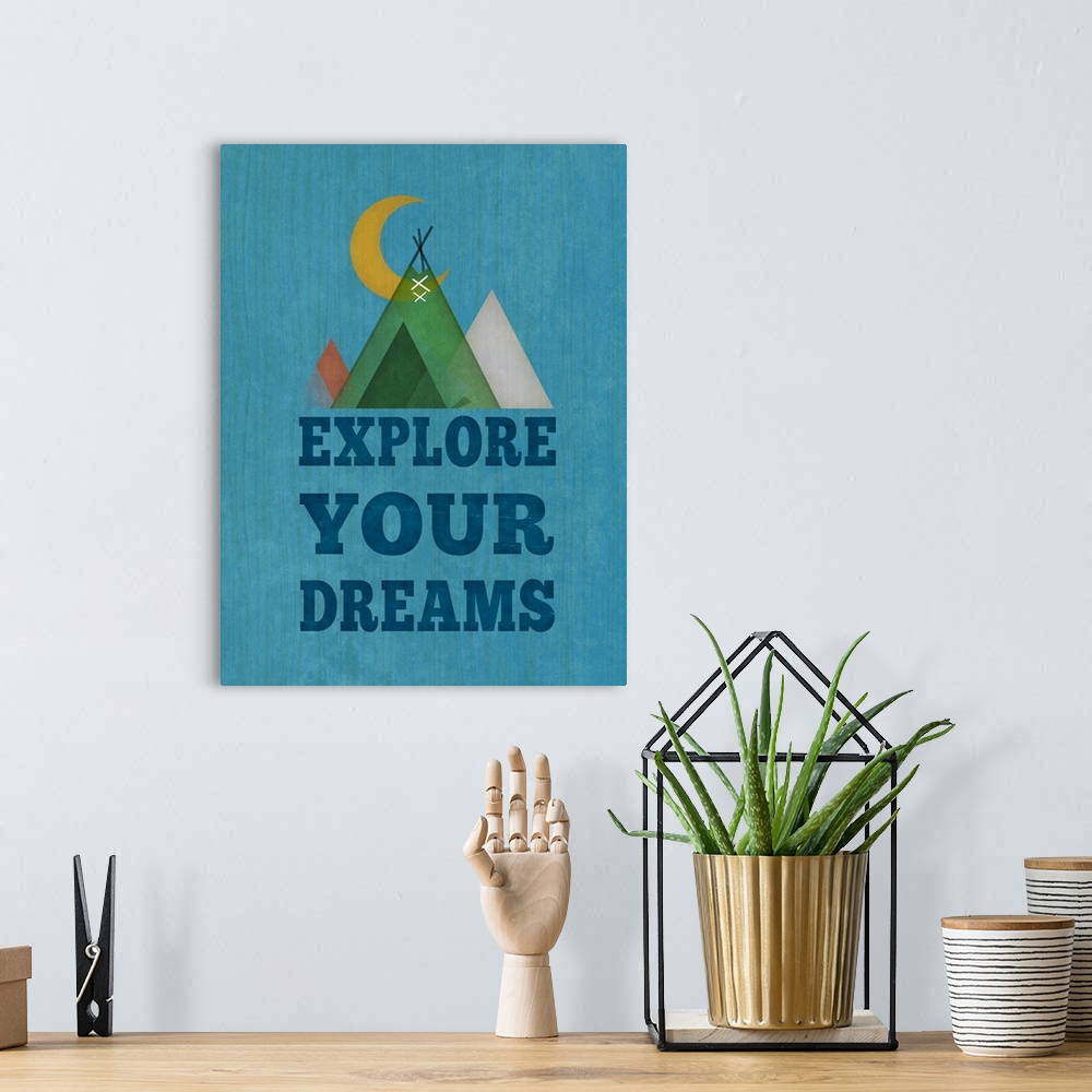 A bohemian room featuring Simple artwork of a crescent moon and a set of tents with "Explore your dreams."