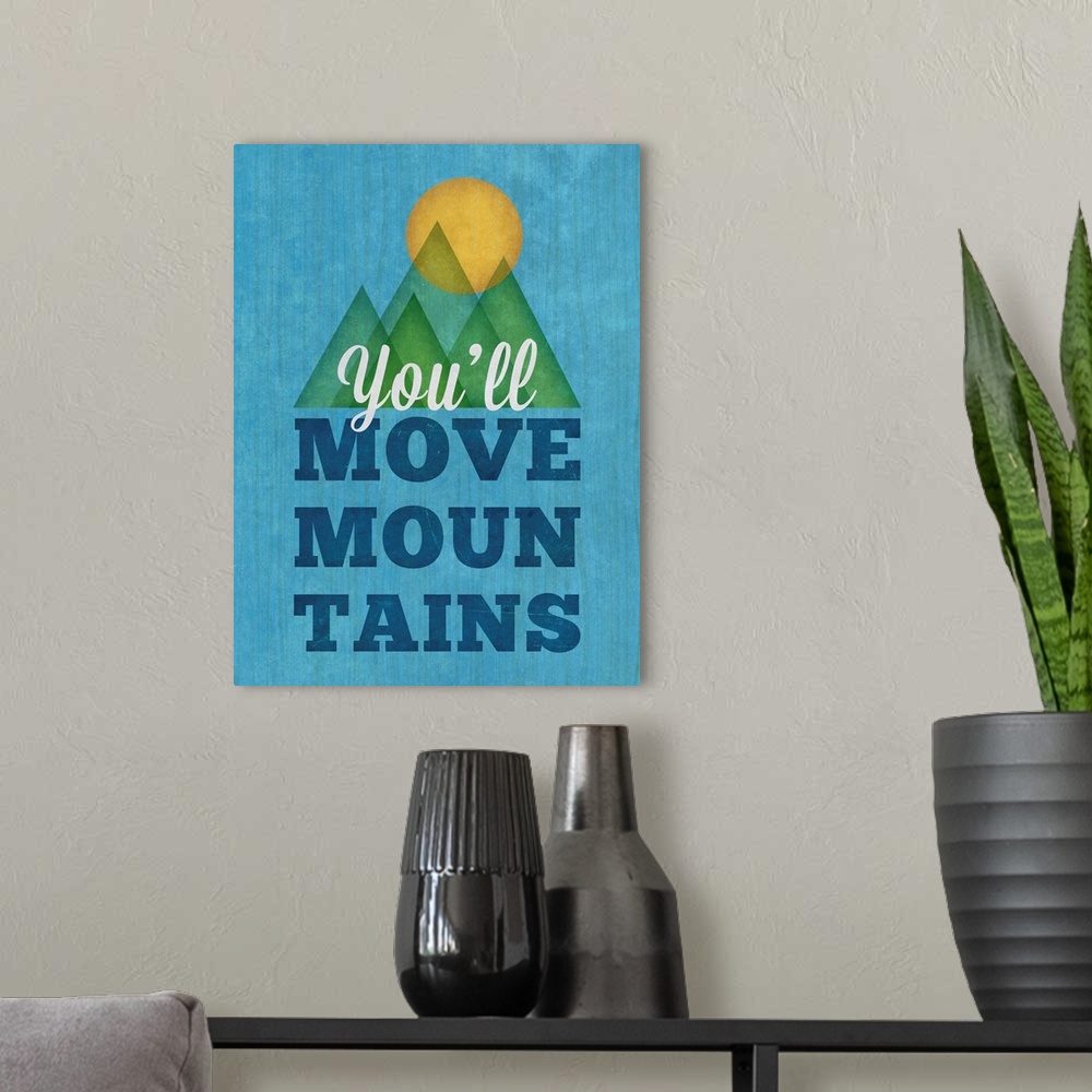 A modern room featuring Cute artwork of the sun over some mountains with "You'll move mountains."