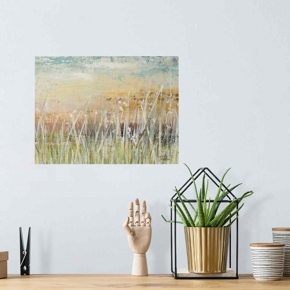 A bohemian room featuring A contemporary landscape painting with pale colors and white, tall grass in the foreground.