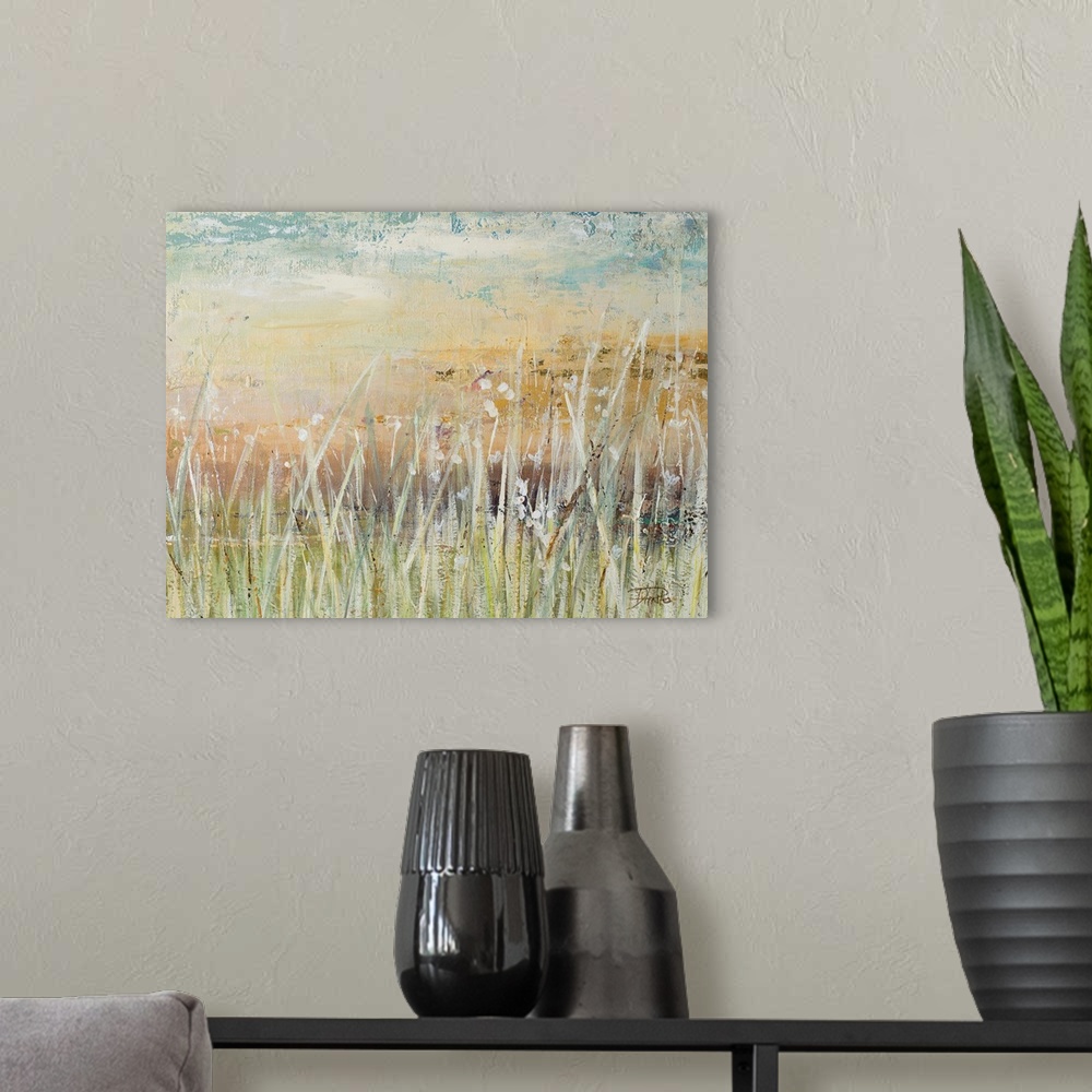 A modern room featuring A contemporary landscape painting with pale colors and white, tall grass in the foreground.