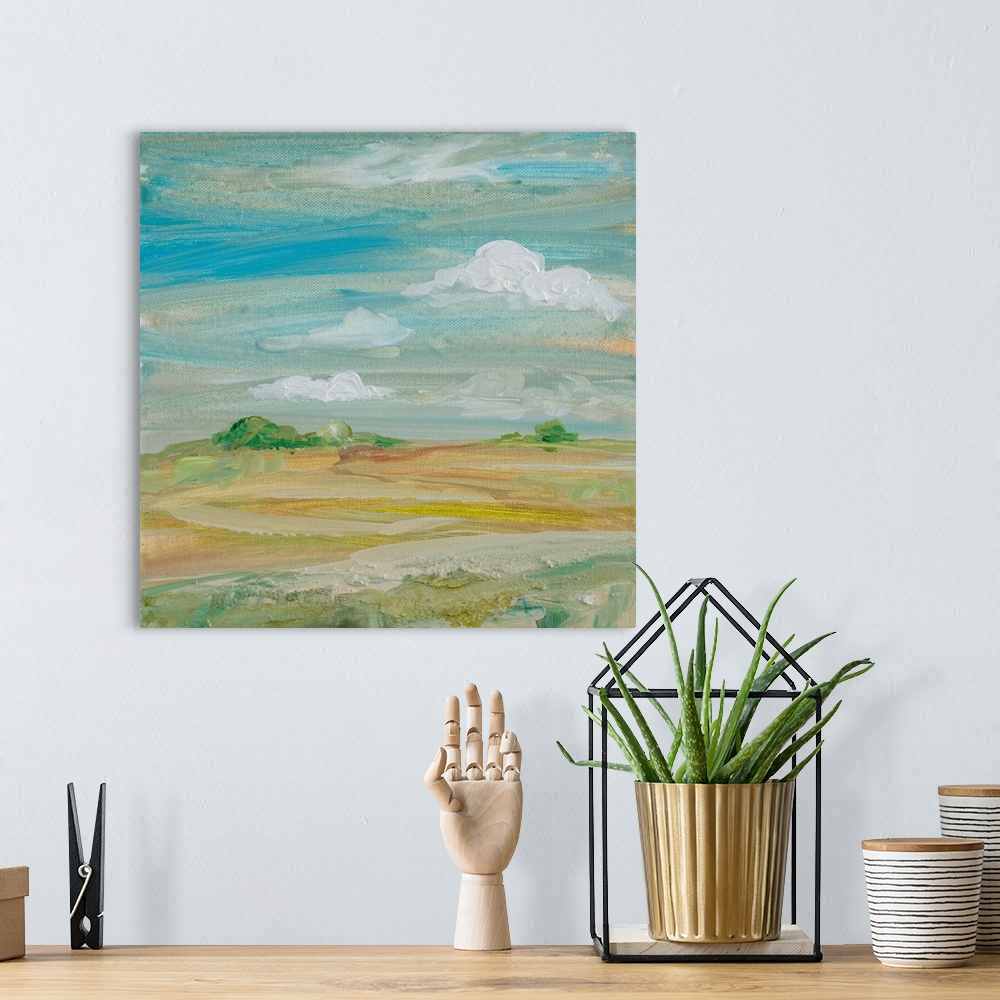 A bohemian room featuring Contemporary painting of a landscape under a cloudy sky.
