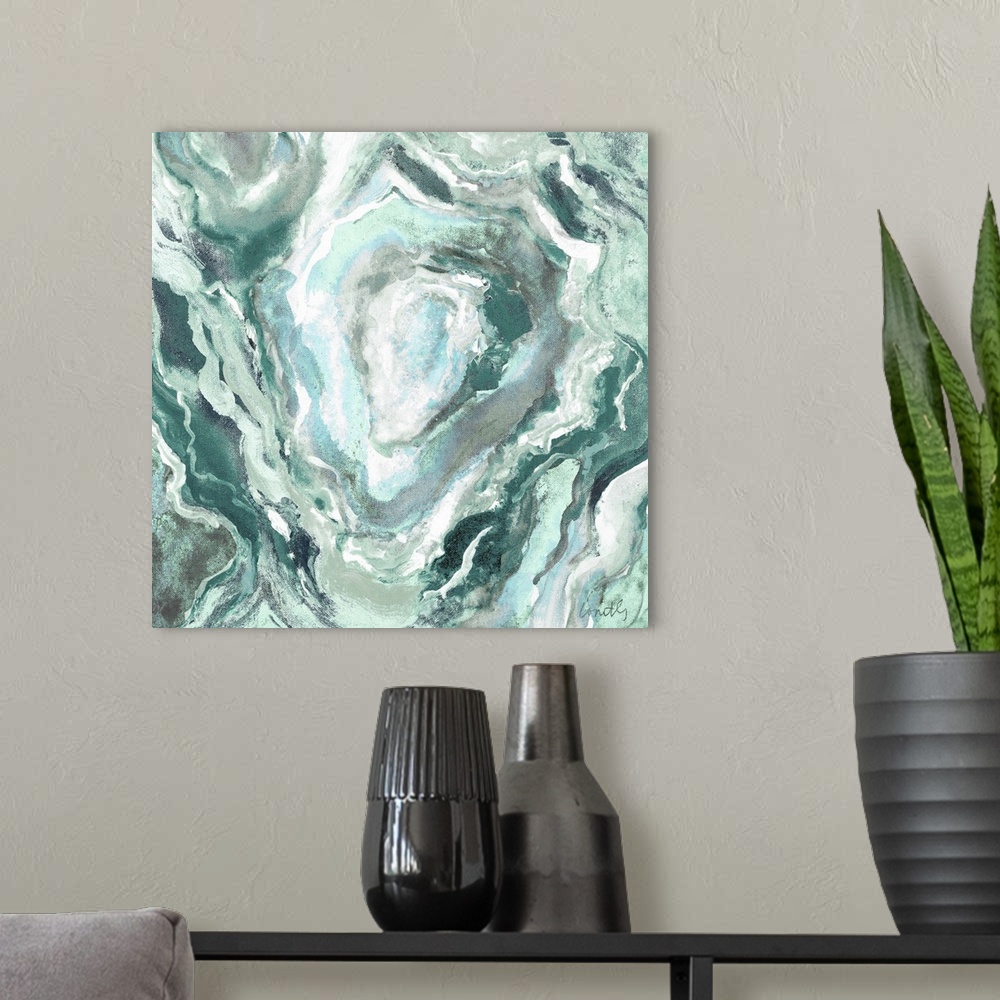 A modern room featuring Square abstract painting of quartz showing the agate in shades of green, blue, and white.