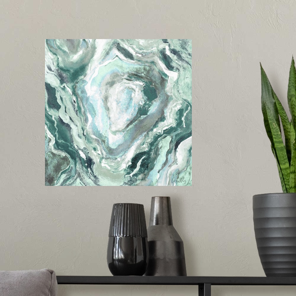 A modern room featuring Square abstract painting of quartz showing the agate in shades of green, blue, and white.