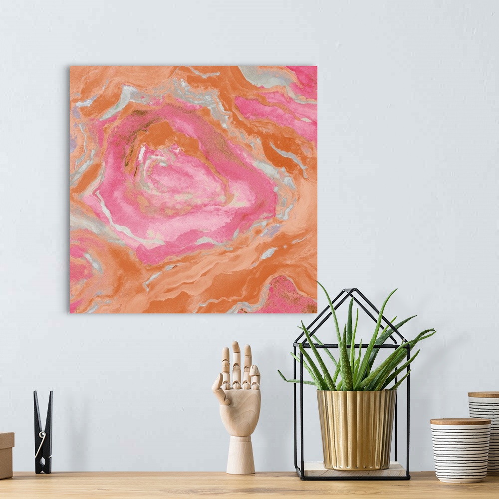 A bohemian room featuring Square abstract painting of quartz showing the agate in light shades of orange, pink, and gray.