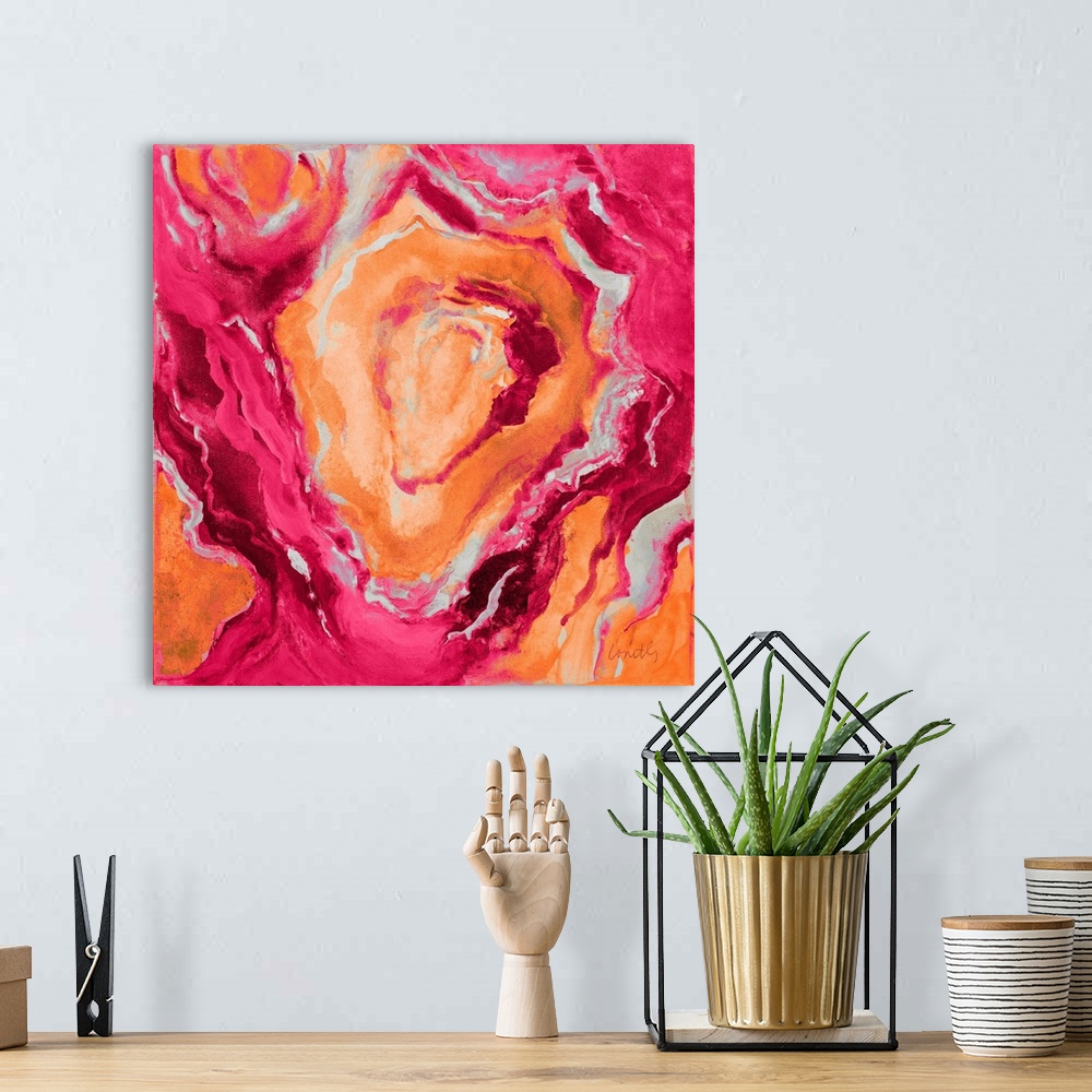 A bohemian room featuring Square abstract painting of quartz showing the agate in dark shades of orange, pink, and gray.