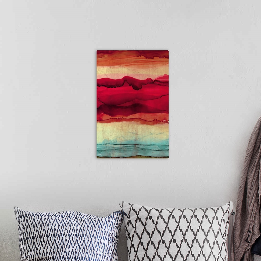 A bohemian room featuring Abstract painting with orange, pink, red, and blue hues layered together to resemble mountains.