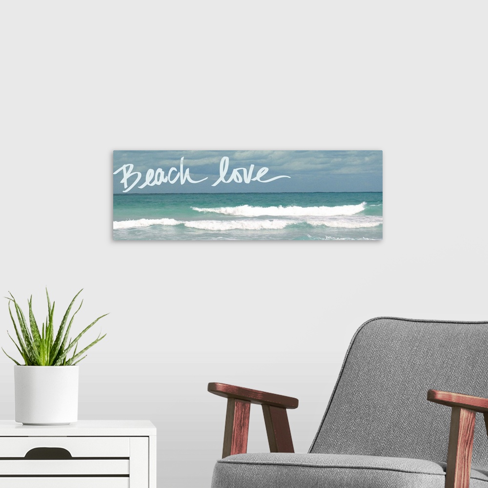 A modern room featuring Horizontal photograph of rolling waves in the ocean with "Beach love" handwritten in the sky.