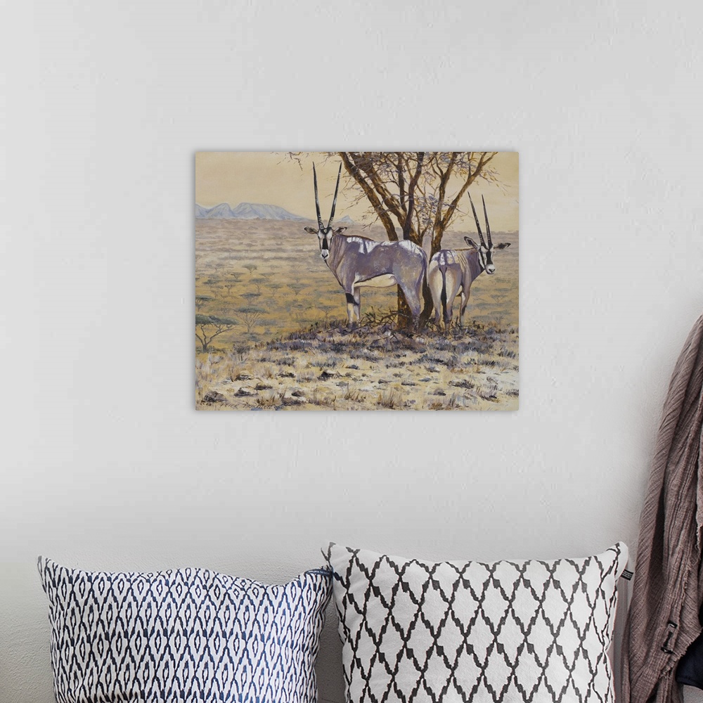 A bohemian room featuring Painting of two Oryxes standing next to a tree in the African plain.