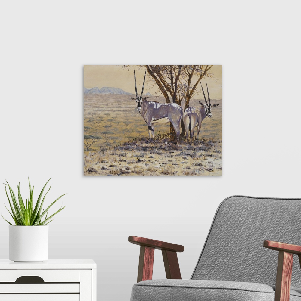 A modern room featuring Painting of two Oryxes standing next to a tree in the African plain.