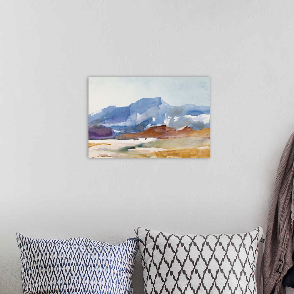 A bohemian room featuring Watercolor landscape painting of a mountain rising over a field.