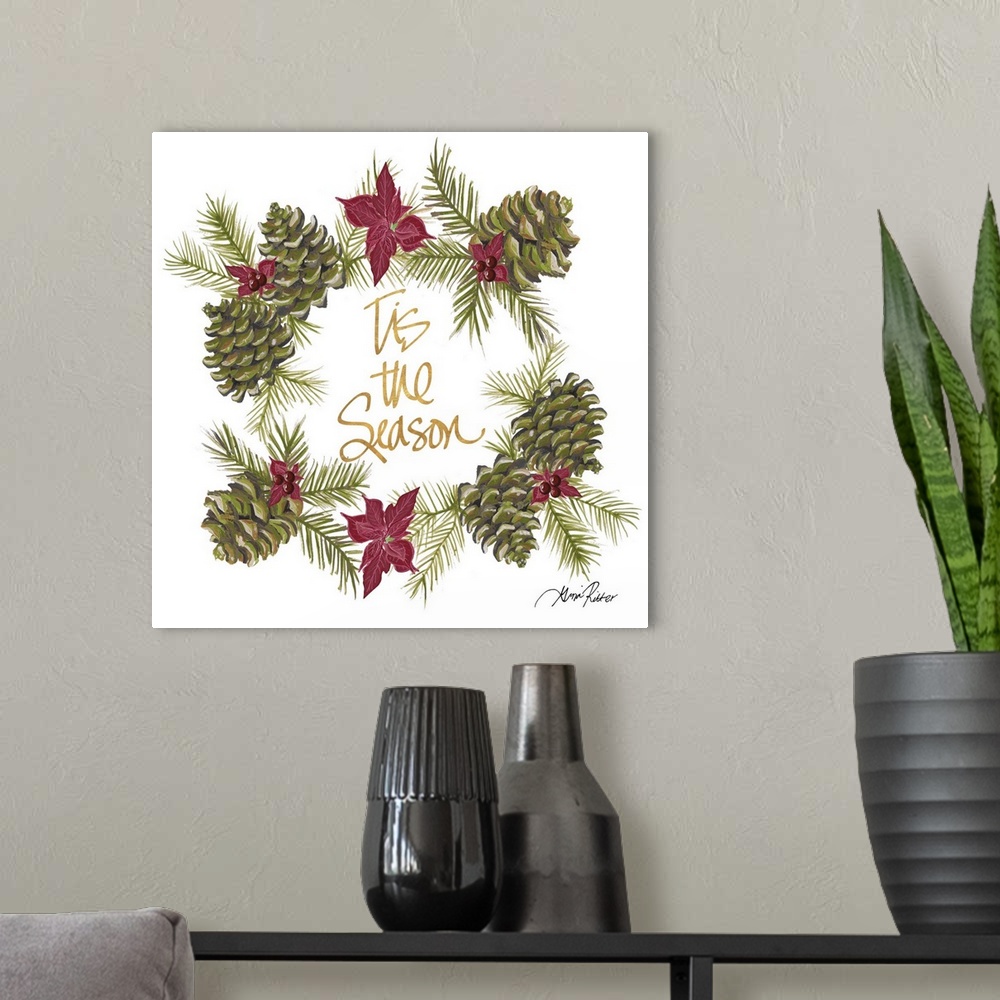 A modern room featuring Golden lettering in the center of a wreath made of pinecones and poinsettias.